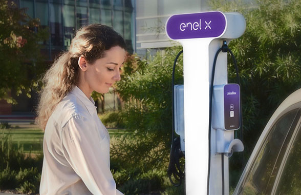 woman charging electric vehicle at commercial charging station