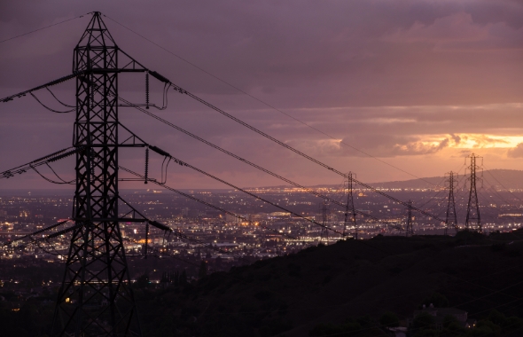 electrical tower overlooking city at night