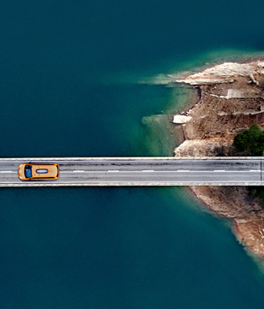 aerial photo of car on bridge