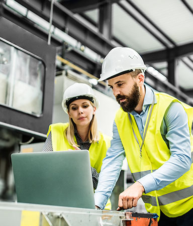factory workers on laptop