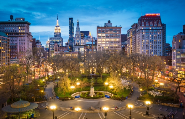 lights in union square and new york city skyline