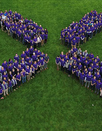 Enel X team standing in an X formation