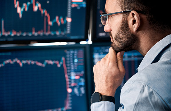 two business women working together on laptop in factory warehouse