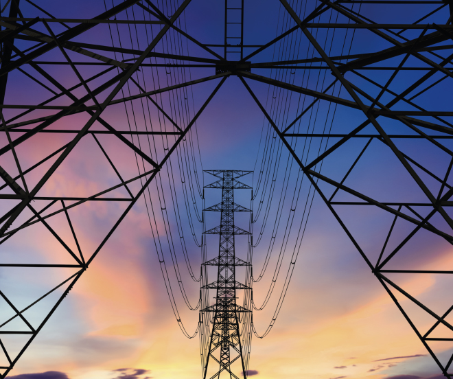 Transmission towers with sunset in background