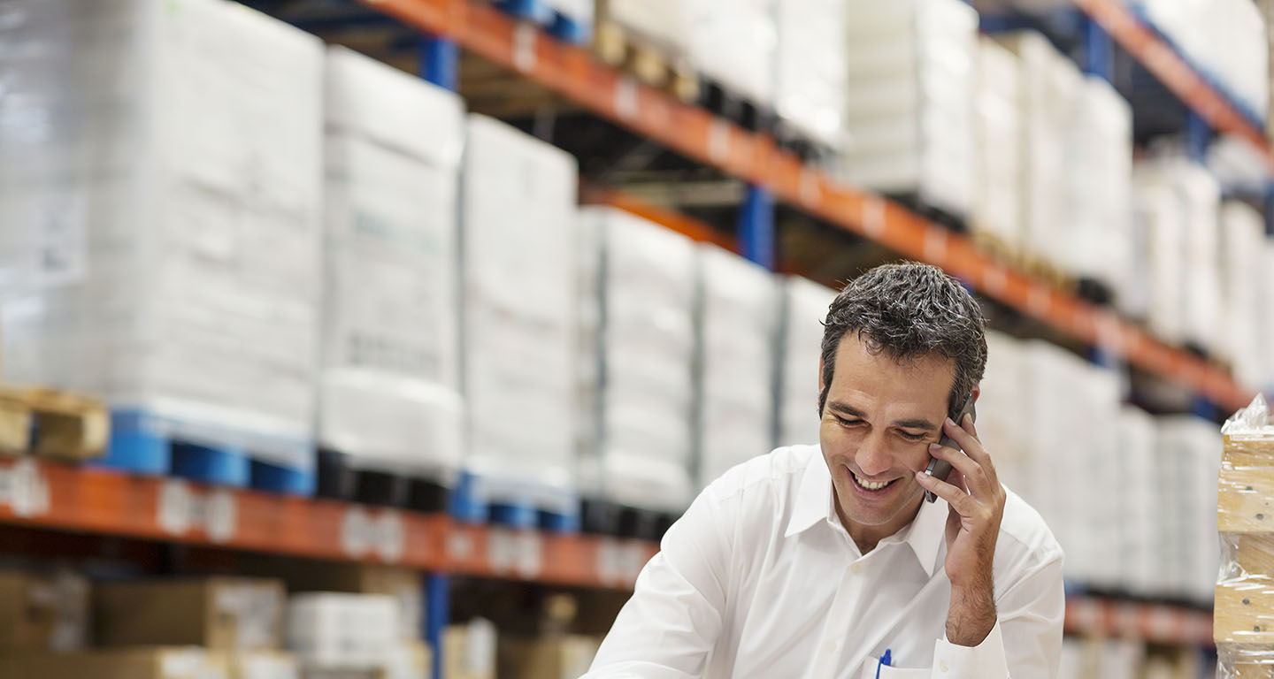 man on phone in warehouse