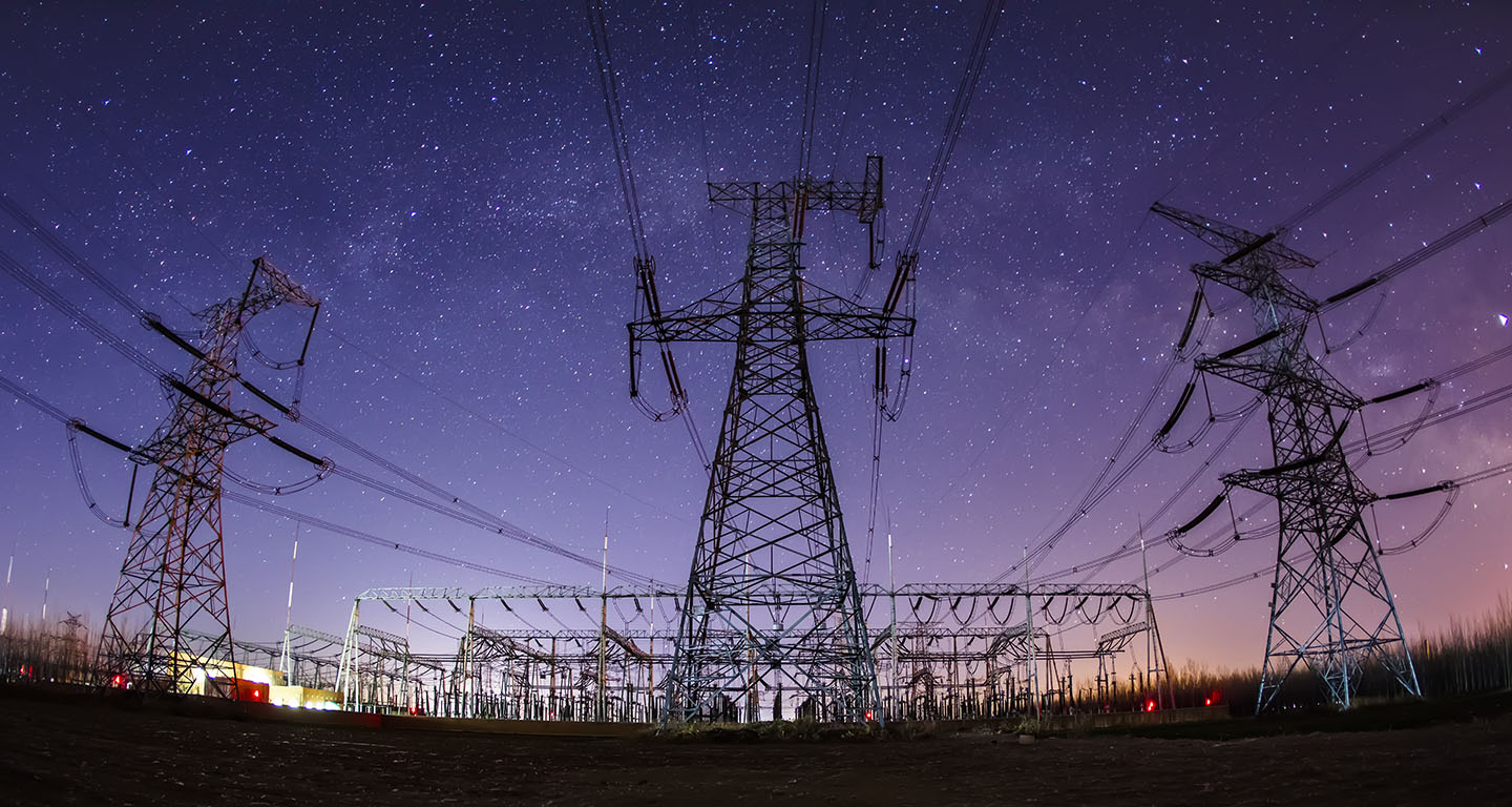 electricity towers under a starry sky
