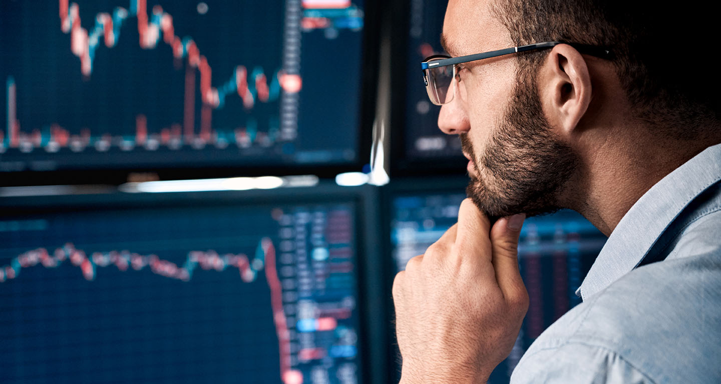 Professional analyzing graphs on monitor